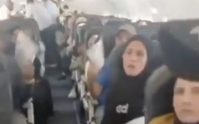 Palestinians fleeing Gaza sit aboard a plane detained at O.R. Tambo Airport in Johannesburg, South Africa, November 13, 2025. (Screen capture: X)